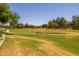 Community walking path winding through lush green space, perfect for relaxing strolls at 17038 W Mohave St, Goodyear, AZ 85338