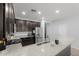 Modern kitchen boasts granite countertops, stainless steel appliances, and dark wood cabinetry at 17038 W Mohave St, Goodyear, AZ 85338