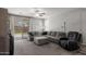 Comfortable living room with a large sectional sofa and a view of the well-maintained yard at 17038 W Mohave St, Goodyear, AZ 85338
