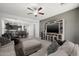 Cozy living room featuring a ceiling fan, large TV, and inviting decor at 17038 W Mohave St, Goodyear, AZ 85338