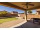 Back patio with brick pavers, view of the backyard and string lights at 17038 W Mohave St, Goodyear, AZ 85338