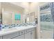 Bathroom with double sinks, decorative tile backsplash, framed mirrors and large shower at 17154 W Las Palmaritas Dr, Waddell, AZ 85355