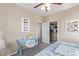 Charming bedroom with blue desk, chair, and a view of the closet for ample storage at 17154 W Las Palmaritas Dr, Waddell, AZ 85355