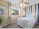 Bright bedroom featuring large window, neutral walls and a comfortable bed at 17154 W Las Palmaritas Dr, Waddell, AZ 85355