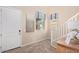 Inviting entryway with tile floors, white door, staircase, and natural light from nearby windows at 17154 W Las Palmaritas Dr, Waddell, AZ 85355