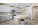 Modern kitchen with sleek grey cabinets, stainless steel appliances, island, and pendant lighting at 17154 W Las Palmaritas Dr, Waddell, AZ 85355