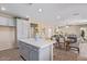 Open-concept kitchen and dining area featuring a large island and stainless steel appliances at 17154 W Las Palmaritas Dr, Waddell, AZ 85355