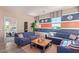 Stylish living room with blue sofas, baseball decor, and a unique coffee table at 17154 W Las Palmaritas Dr, Waddell, AZ 85355