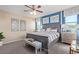Comfortable bedroom features a large bed, neutral color palette, and large windows with great views at 17154 W Las Palmaritas Dr, Waddell, AZ 85355