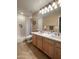 Well-lit bathroom with a double vanity, tile flooring, and a shower-tub combination at 17658 N 52Nd Pl, Scottsdale, AZ 85254