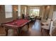 Spacious game room with a pool table and a dining table in the background at 17658 N 52Nd Pl, Scottsdale, AZ 85254