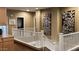 Upstairs hallway with white banister and neutral wall color with wall art at 17658 N 52Nd Pl, Scottsdale, AZ 85254