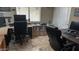 Home office with multiple desks, rolling office chairs, multiple monitors and tiled floor at 17658 N 52Nd Pl, Scottsdale, AZ 85254