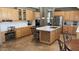 Modern kitchen with an island, stainless steel appliances, and light wood cabinets at 17658 N 52Nd Pl, Scottsdale, AZ 85254