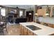 Open floor plan featuring a kitchen with stainless steel appliances and a stone fireplace living room at 17658 N 52Nd Pl, Scottsdale, AZ 85254