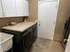 Functional laundry room with a front-loading washer and dryer and countertop workspace at 17658 N 52Nd Pl, Scottsdale, AZ 85254