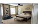 A bright main bedroom with carpet, bench, king bed, ceiling fan, decor and workout equipment at 17658 N 52Nd Pl, Scottsdale, AZ 85254
