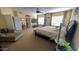 Large main bedroom with sitting area, furnishings, decor, ceiling fan and access to other rooms at 17658 N 52Nd Pl, Scottsdale, AZ 85254