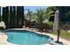 Sparkling pool with beach balls, sun umbrellas, and lush landscaping at 17658 N 52Nd Pl, Scottsdale, AZ 85254