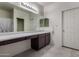 Bathroom features long countertop with cabinets, and a large mirror with vanity lighting at 17946 W Via Del Sol --, Surprise, AZ 85387