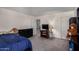 Bedroom featuring a dresser, closet, television, and a doorway leading to another room at 17946 W Via Del Sol --, Surprise, AZ 85387
