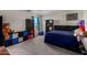 A bedroom with a teddy bear, black bookshelves, and a blue accent pillow at 17946 W Via Del Sol --, Surprise, AZ 85387