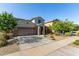 Two-story stucco home featuring a two-car garage, low maintenance landscaping, and covered entryway at 17946 W Via Del Sol --, Surprise, AZ 85387