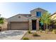 Two-story stucco home featuring a two-car garage, low maintenance landscaping, and covered entryway at 17946 W Via Del Sol --, Surprise, AZ 85387