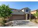 Two-story stucco home featuring a two-car garage, low maintenance landscaping, and covered entryway at 17946 W Via Del Sol --, Surprise, AZ 85387