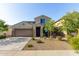Two-story stucco home featuring a two-car garage, low maintenance landscaping, and covered entryway at 17946 W Via Del Sol --, Surprise, AZ 85387