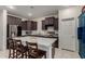Spacious kitchen boasts dark cabinets, stainless appliances, and island with breakfast bar seating at 17946 W Via Del Sol --, Surprise, AZ 85387