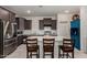 A spacious kitchen with dark cabinets, stainless appliances, and an island with seating at 17946 W Via Del Sol --, Surprise, AZ 85387