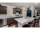 Kitchen features dark cabinets, stainless appliances, and island with breakfast bar at 17946 W Via Del Sol --, Surprise, AZ 85387
