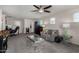 Living room featuring a ceiling fan, a sofa, and a table at 17946 W Via Del Sol --, Surprise, AZ 85387