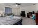 Open main bedroom with ceiling fan, comfortable sitting area with sofa and desk space at 17946 W Via Del Sol --, Surprise, AZ 85387