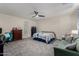 Spacious main bedroom features a ceiling fan and comfortable seating area with carpeting at 17946 W Via Del Sol --, Surprise, AZ 85387