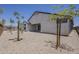 Rear exterior featuring a neutral paint color, and a gravel backyard with sparse desert trees at 18766 N Salerno Dr, Maricopa, AZ 85138
