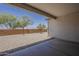 View of covered patio overlooking the backyard with gravel and young trees at 18766 N Salerno Dr, Maricopa, AZ 85138