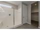 Bright shower area featuring tiled walls, glass enclosure, and a convenient bench, perfect for relaxation at 18766 N Salerno Dr, Maricopa, AZ 85138