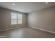 Spacious bedroom with neutral paint, wood-look tile flooring, recessed lighting and a large window at 18766 N Salerno Dr, Maricopa, AZ 85138