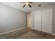 Cozy bedroom featuring neutral walls, carpeted floors, and a closet with sliding doors at 18766 N Salerno Dr, Maricopa, AZ 85138