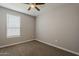 Bedroom with neutral walls, carpeted floor, and a window that brings natural light in the room at 18766 N Salerno Dr, Maricopa, AZ 85138
