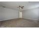 Spacious bedroom with neutral walls, carpeted floor, and a ceiling fan for a comfortable living space at 18766 N Salerno Dr, Maricopa, AZ 85138