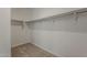 Walk-in closet featuring ample shelving and storage space for clothing and accessories at 18766 N Salerno Dr, Maricopa, AZ 85138