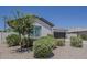 View of a cozy single-story home featuring a two-car garage and desert landscaping at 18766 N Salerno Dr, Maricopa, AZ 85138