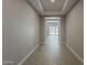 Inviting hallway with tiled floors and a view towards the backyard at 18766 N Salerno Dr, Maricopa, AZ 85138