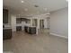 Open concept kitchen with large island and stainless steel appliances next to the dining area at 18766 N Salerno Dr, Maricopa, AZ 85138