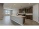 A spacious kitchen featuring a large island, stainless steel appliances, and modern cabinetry at 18766 N Salerno Dr, Maricopa, AZ 85138