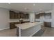 Modern kitchen with an island, stainless steel appliances, and plenty of countertop space at 18766 N Salerno Dr, Maricopa, AZ 85138