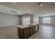 Kitchen island featuring stainless steel appliances, brown cabinets and white countertop at 18766 N Salerno Dr, Maricopa, AZ 85138